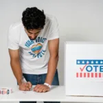 a man writing on a ballot