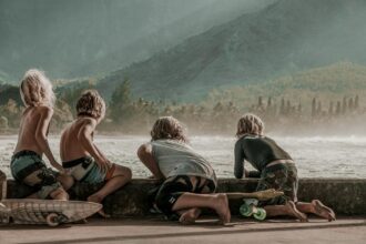 four children looking at sea