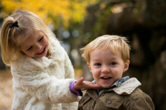 girl holding the chin of boy outdoor