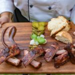 photo of grilled meat on wooden chopping board