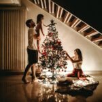 family decorating their christmas tree