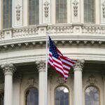 flag of america waving near white concrete building