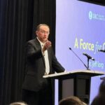 Jeff Iorg, CEO of the Southern Baptist Convention, addressing meeting attendees from behind a lectern.