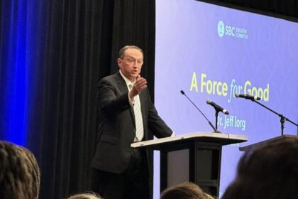Jeff Iorg, CEO of the Southern Baptist Convention, addressing meeting attendees from behind a lectern.