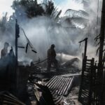 silhouette of fireman holding hose