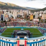 Estadio Félix Capriles in Cochabamba, Bolivia, filled with thousands seeking hope during Esperanza Cochabamba with Will Graham, framed by the stunning Andes mountains in the backdrop.