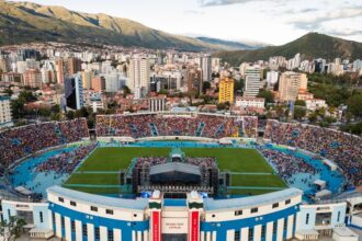 Estadio Félix Capriles in Cochabamba, Bolivia, filled with thousands seeking hope during Esperanza Cochabamba with Will Graham, framed by the stunning Andes mountains in the backdrop.