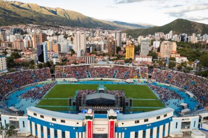 Estadio Félix Capriles in Cochabamba, Bolivia, filled with thousands seeking hope during Esperanza Cochabamba with Will Graham, framed by the stunning Andes mountains in the backdrop.