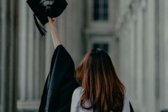 Adult graduate in cap and gown illustrating Long Beach Public Library's diploma program