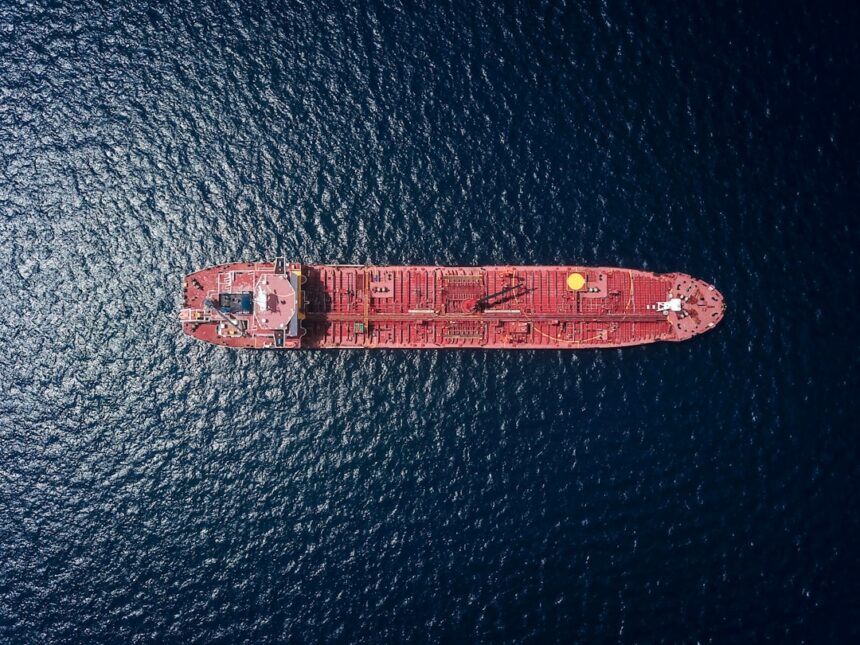 Aerial view of an oil tanker at sea, illustrating shipping risks around the Strait of Hormuz