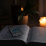 An open Bible illuminated by warm candlelight