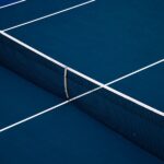 Blue hard-court tennis surface illustrating Ben Shelton’s late-night U.S. Open victory.