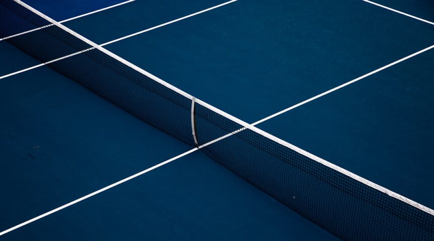 Blue hard-court tennis surface illustrating Ben Shelton’s late-night U.S. Open victory.