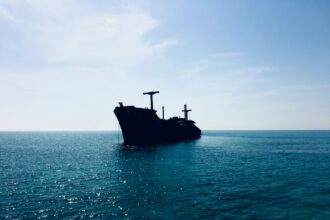 Cargo ship at sea representing shipping through the Strait of Hormuz