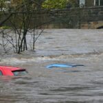 Cars partially submerged by severe street flooding