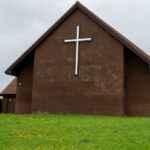 Church exterior with a cross, representing houses of worship