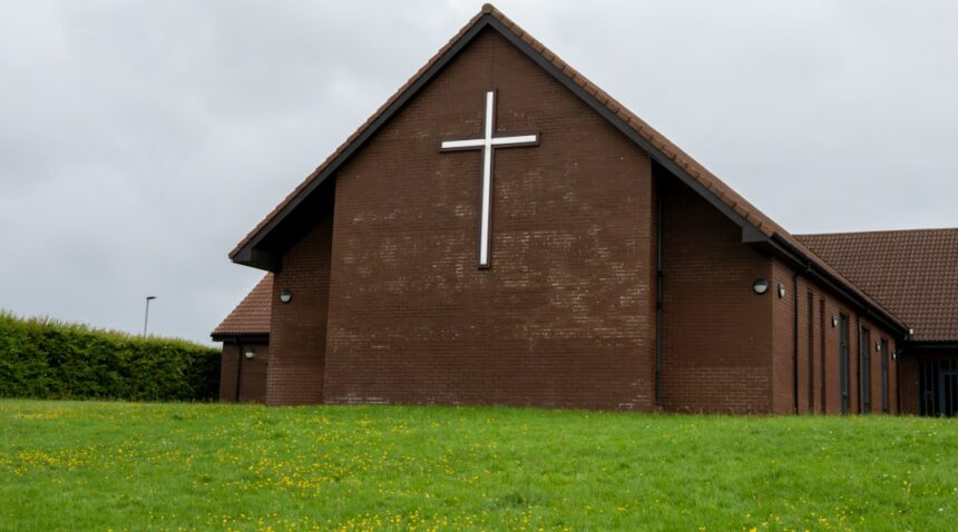 Church exterior with a cross, representing houses of worship