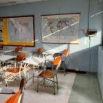 Classroom with desks and a wall map