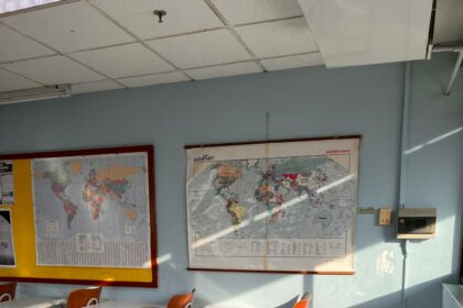 Classroom with desks and a wall map