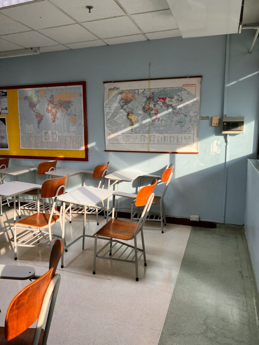 Classroom with desks and a wall map