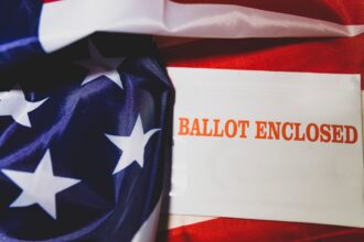 Close-up of an American election ballot and flag