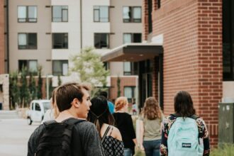 College students walking across campus as Christian groups challenge recognition rules at SUNY Broome