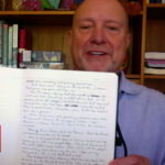 Don Ashley with handwritten New Testament journals during a CBN News interview