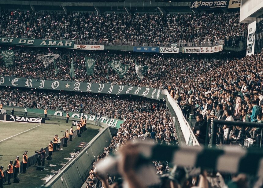 Fans watching a sporting event in a stadium at night
