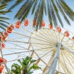 Festival scene with palm trees and Ferris wheel in Southern California