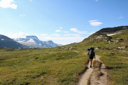 Hiker walking through a mountain landscape.