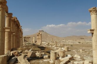 Historic stone architecture in Syria under a clear blue sky.