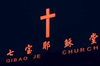 Illuminated cross on a building in Shanghai, used as an illustrative image for religious-freedom reporting