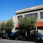Industrial manufacturing building with parked cars