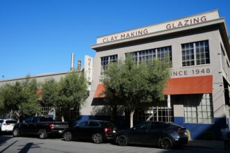 Industrial manufacturing building with parked cars