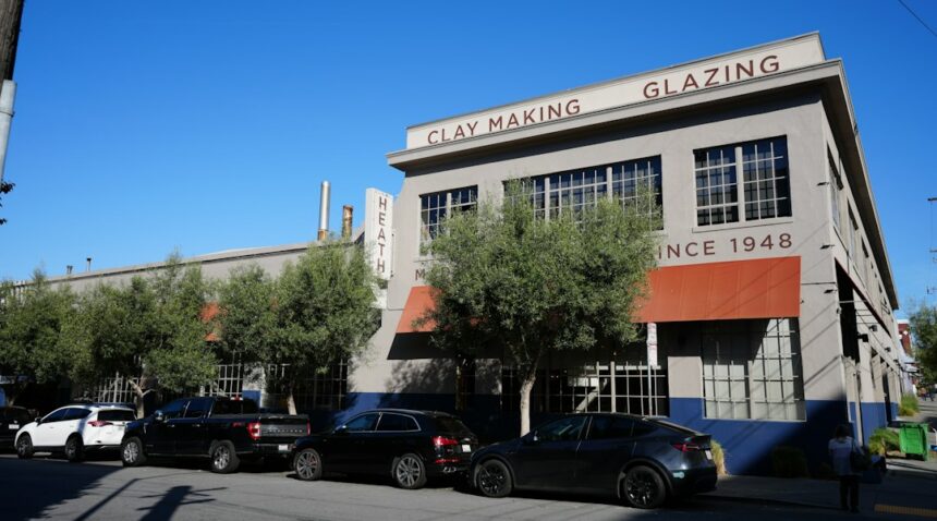 Industrial manufacturing building with parked cars