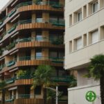 Modern apartment buildings with balconies and palm trees