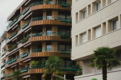 Modern apartment buildings with balconies and palm trees