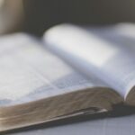 Open Bible and study materials on a desk, illustrating questions about artificial intelligence and Scripture interpretation