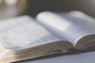 Open Bible and study materials on a desk, illustrating questions about artificial intelligence and Scripture interpretation