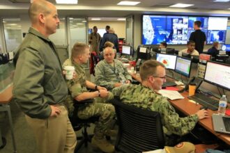Personnel work inside FEMA’s National Response Coordination Center during a 2019 hurricane response.