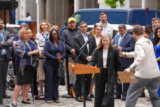 Public speaker at a microphone illustrating Long Beach City Council public comment changes