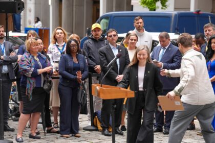 Public speaker at a microphone illustrating Long Beach City Council public comment changes