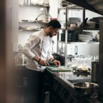 Restaurant chef preparing vegetables illustrating food-safety monitoring