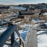 Snowy Greenland coastal village and Arctic landscape