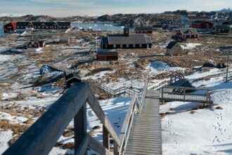 Snowy Greenland coastal village and Arctic landscape