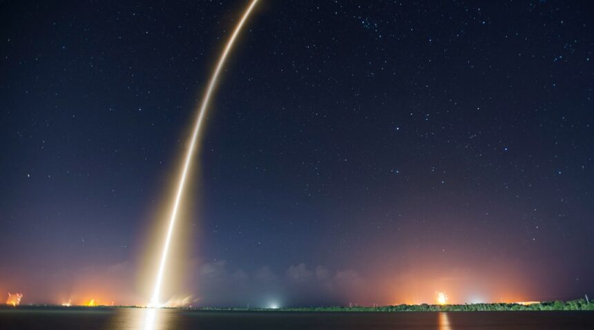 SpaceX rocket launch illuminating the night sky