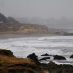 Storm-driven ocean waves crashing along a rocky coast