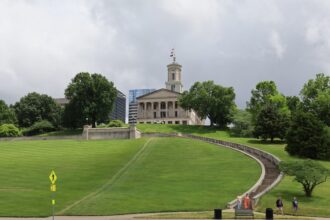 Tennessee State Capitol in Nashville beneath a partly cloudy sky.