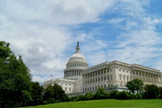 The United States Capitol beneath a dramatic cloudy sky in Washington.