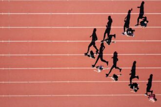 Track athletes running in a stadium